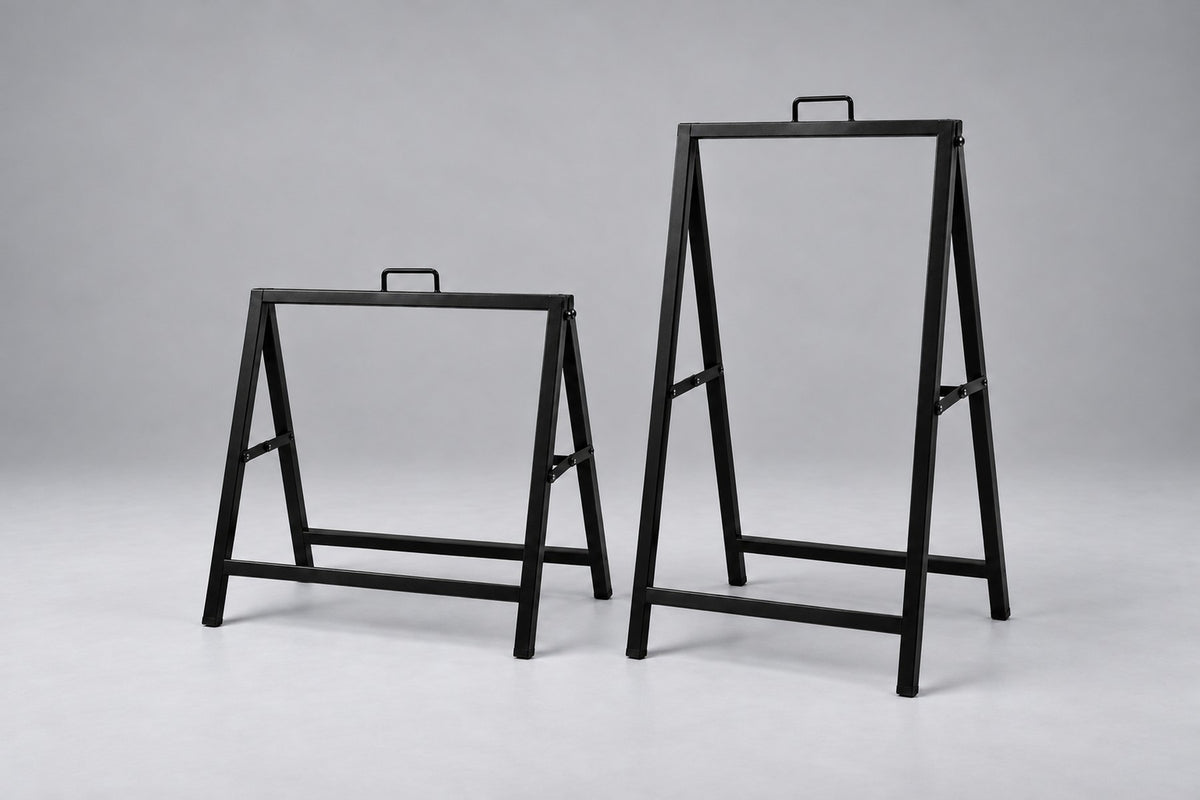 Empty black metal A-frame sign holders in two sizes