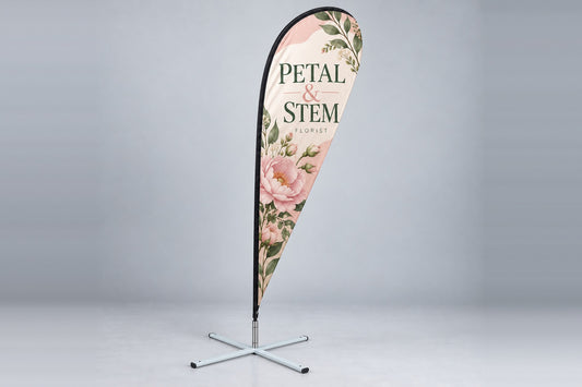 Custom teardrop flag with a floral design on a cross base