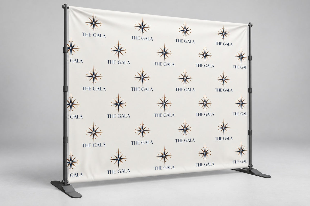 Banner backdrop with a repeating gala logo step-and-repeat on a telescopic stand