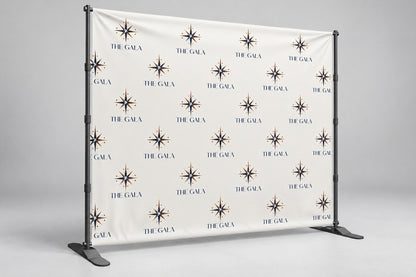 Banner backdrop with a repeating gala logo step-and-repeat on a telescopic stand